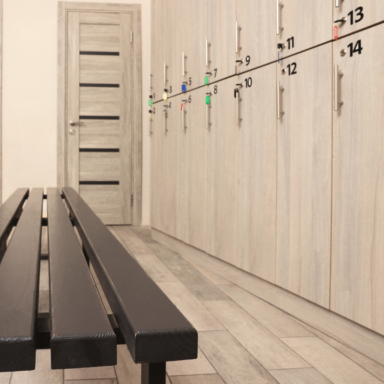 light cream wood changing room with black bench